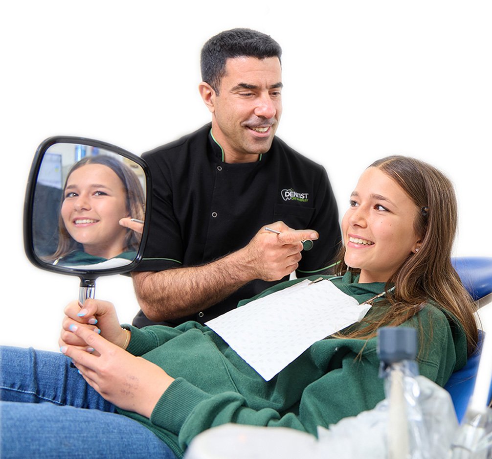 A dentist chatting with a teenage patient in the surgery at Dentist on Waverley
